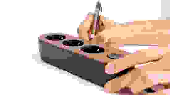 mynolla-power-strip-black-walnut-hands.jpg